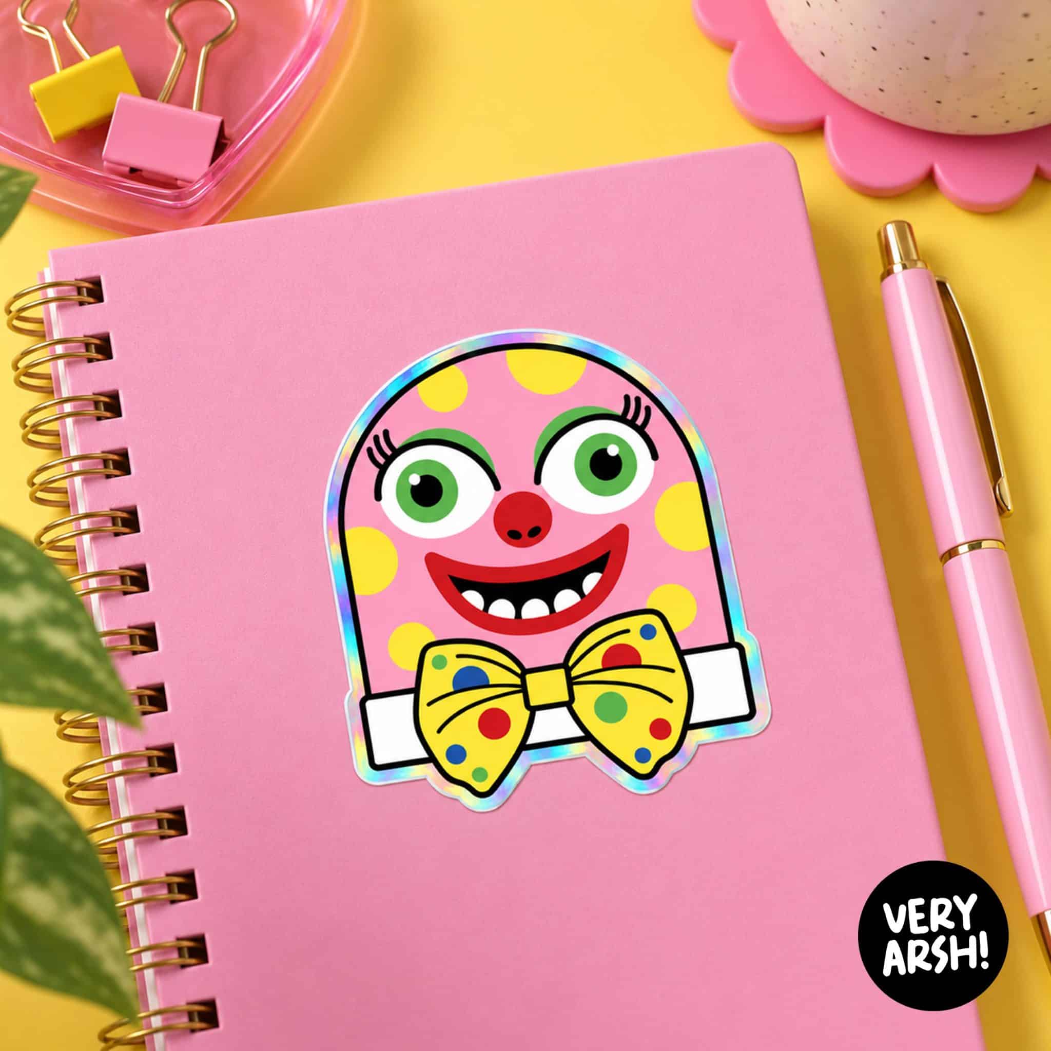 Mr Blobby Holographic Vinyl Sticker on a notepad